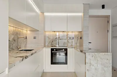 a kitchen with white cabinets and a sink at The Smart Concierge - Bay Central in Dubai