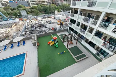 an overhead view of a pool on a apartment building at Escape24 Elegant 1BR in JVC with Pool View in Dubai