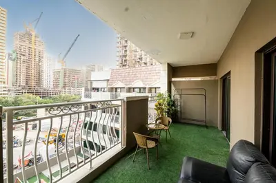 a balcony with a view of a city at Escape24 Elegant 1BR in JVC with Pool View in Dubai