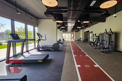 a gym with treadmills and ellipticals in a building at Beautiful Brand New Spacious in Dubai