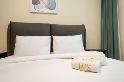 a bed with a pillow on top of it at Chic and Urban 1-Bed Business Bay Suite in Dubai