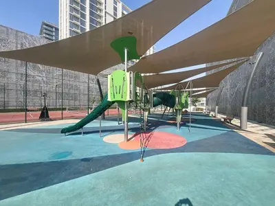 a park with a playground with a slide at Vacationer l Serene 3 Bed Haven l Private Beach l District One in Dubai