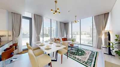 a dining room and living room with a table and chairs at Vacationer l Serene 3 Bed Haven l Private Beach l District One in Dubai