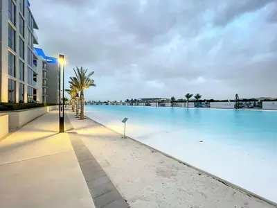 a large swimming pool next to a building at Vacationer l Stunning 1 Bed l Private Beach l near Downtown in Dubai
