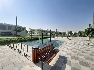 a park with a wooden bench and a playground at Vacationer l Stunning 1 Bed l Private Beach l near Downtown in Dubai