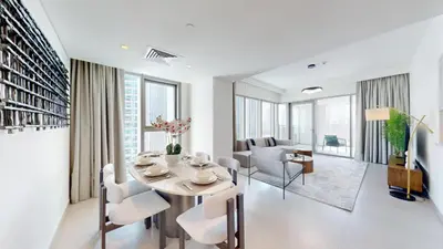 a white living room with a table and chairs at Vacationer I Luxury 3 Bedroom Apartment I Iconic Burj Khalifa View I Heart of Downtown in Dubai