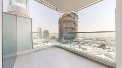 an empty room with a large window in a building at Vacationer I Premium Studio I Pool & Gym Access I Near Miracle Garden I Opalz Tower 2 in Dubai