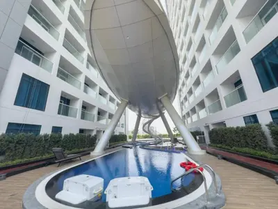 a swimming pool in front of a building at Vacationer I Premium Studio I Pool & Gym Access I Near Miracle Garden I Opalz Tower 2 in Dubai