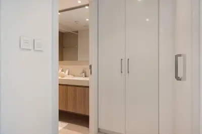 a bathroom with white cabinets and a sink at Luxury 2 bedroom with Burj Khalifa view, connected to Dubai Mall in Dubai