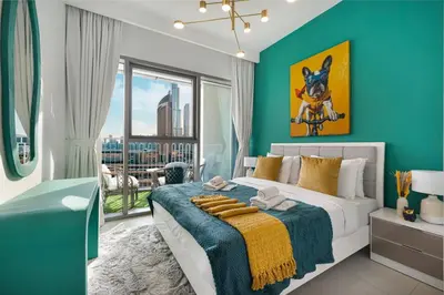 a bedroom with a large bed with a blue wall at Luxury 2 bedroom with Burj Khalifa view, connected to Dubai Mall in Dubai
