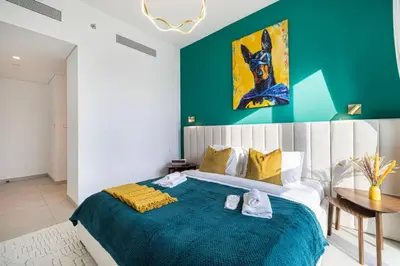a bedroom with a large bed with a green wall at Luxury 2 bedroom with Burj Khalifa view, connected to Dubai Mall in Dubai