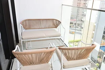 two chairs and a table on a balcony at Apartamento Dune en Dubái por beBalmy in Dubai