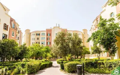 a large building with trees in front of a courtyard at Palmoral Collection Stunning Studio with Dining Area in Dubai
