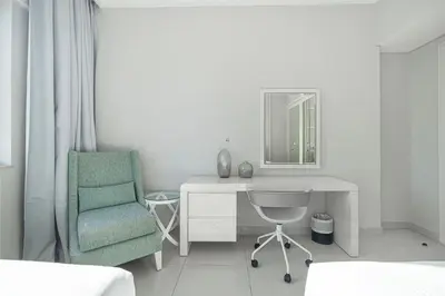 a bedroom with a desk and a chair and a mirror at Burj Khalifa view - 2 BR apartment in Downtown in Sabkhah