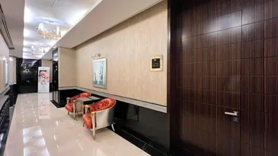 a hallway with red chairs in a building at Burj Khalifa view - 2 BR apartment in Downtown in Sabkhah