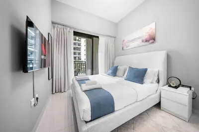a white bedroom with a bed and a window at Stylish & Elegant Stay Prime Business Bay Spot in Dubai