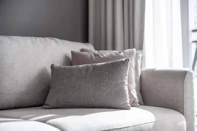 a couch with a pillow on it in front of a window at Stylish & Elegant Stay Prime Business Bay Spot in Dubai