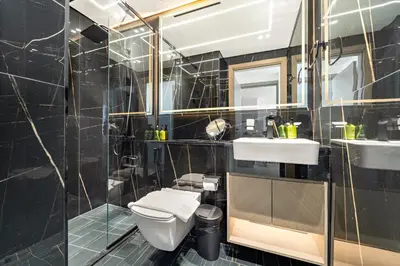 a bathroom with a toilet and a sink and a shower at VayK - Gorgeous 1BR Retreat in Binghatti Corner in Dubai