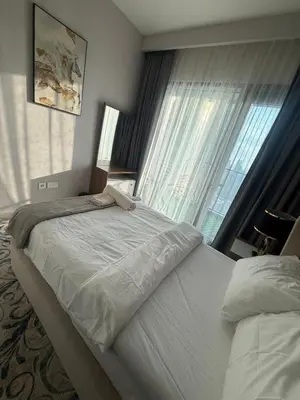 a bedroom with two beds and a large window at Luxury Apartment Downtown views 2 in Dubai