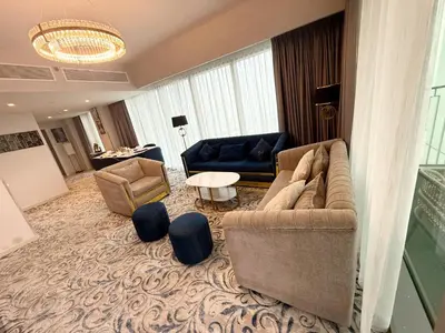 a living room with two couches and a table at Luxury Apartment Downtown views 2 in Dubai