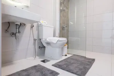 a bathroom with a toilet and a sink and a shower at Vogue JVC Jeewar Tower near Circle Mall, One Bedroom Apartment with Balcony and Park view, Access to all Amenities in Dubai