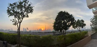a view of a city skyline with trees in the foreground at Deluxe studio water front in Dubai