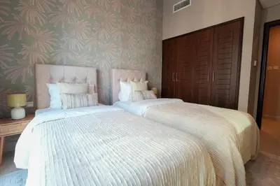two beds sitting next to each other in a bedroom at Luxury Family Friendly Apartment - Full Burj Khalifa & Fountain Views in Dubai