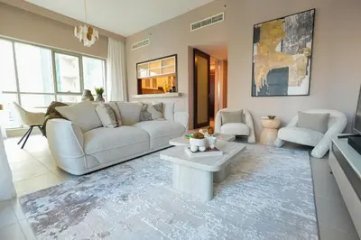 a living room with a couch and a table at Luxury Family Friendly Apartment - Full Burj Khalifa & Fountain Views in Dubai