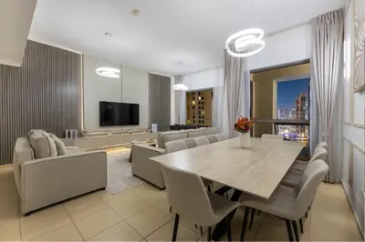 a living room with a table and chairs and a television at JBR Saddaf 4 By Luxe Living - Marina & Sea Views in Dubai