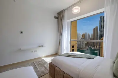 a bedroom with a large window with a view of the city at JBR Saddaf 4 By Luxe Living - Marina & Sea Views in Dubai