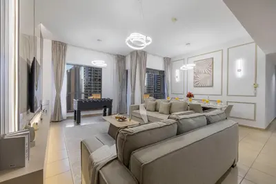 a living room with a couch and a piano at JBR Saddaf 4 By Luxe Living - Marina & Sea Views in Dubai