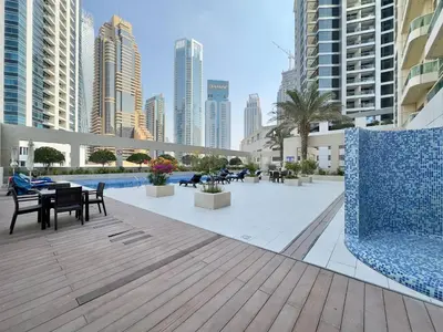 a patio with tables and chairs in a city at Modern & Cozy 1BR Apartment | Dubai Eye View in Dubai