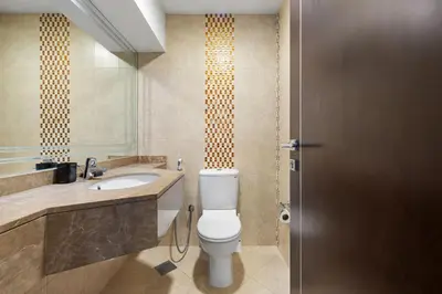 a bathroom with a toilet and a sink at Serene 1BR with Balcony & Pool in Siraj Tower in Dubai