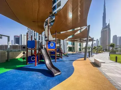 a playground on the roof of a building with a slide at WonderfulStay At Downtown Views II - Best Burj Khalifa View - Direct Dubai Mall Access - Brand New Luxury Apartments in Dubai