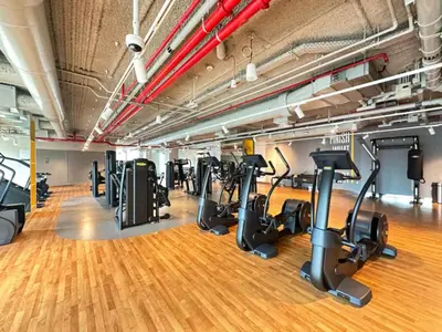 a gym with a row of treadmills and exercise bikes at WonderfulStay At Downtown Views II - Best Burj Khalifa View - Direct Dubai Mall Access - Brand New Luxury Apartments in Dubai
