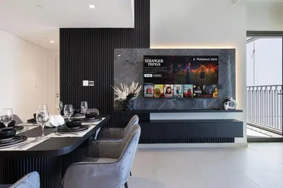 a dining room with two tables and a fireplace at WonderfulStay At Downtown Views II - Best Burj Khalifa View - Direct Dubai Mall Access - Brand New Luxury Apartments in Dubai