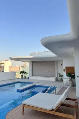 a swimming pool on the roof of a building at PVH - Sleek 1BR near Community Park - Pearl House 1 in Dubai