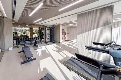 a gym with rows of treadmills and exercise equipment at PVH - Sleek 1BR near Community Park - Pearl House 1 in Dubai
