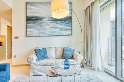 a living room with a couch and a table at PVH - Charming 1BR near Dubai Mall - Burj Royale in Dubai