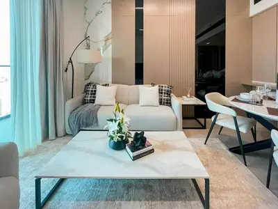 a living room with a couch and a table at Contemporary Luxe Stay at Dawn by Binghatti! in Dubai