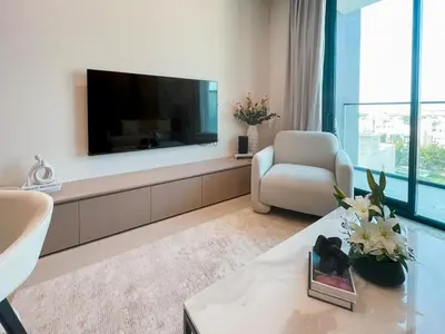a living room with a large flat screen tv at Contemporary Luxe Stay at Dawn by Binghatti! in Dubai