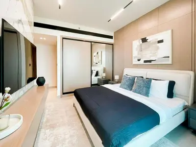 a bedroom with a large bed with blue pillows at Contemporary Luxe Stay at Dawn by Binghatti! in Dubai
