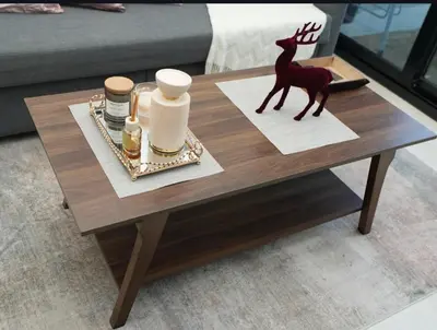 a wooden coffee table with a statue of a deer on it at Flat in Downtown, Pool & Canal view in Dubai