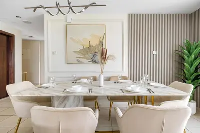 a dining room with a table and chairs at Spacious 3BR with Gym & Pool in Royal Residences in Dubai