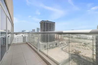a balcony with a view of a city at Spacious 3BR with Gym & Pool in Royal Residences in Dubai