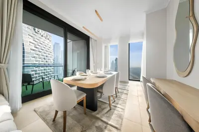 a dining room with a table and chairs and a large window at Luxury 4 BR with full Burj Khalifa and Fountain View - Connected to Dubai Mall and Metro Station in Dubai