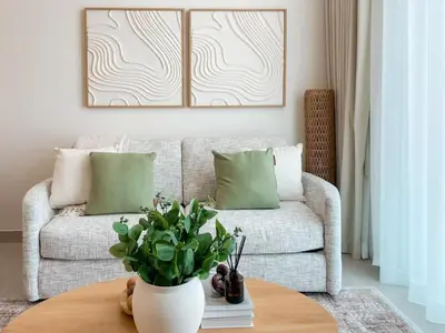 a living room with a couch and a table at Amberwood 2BR Haven at Dawn by Binghatti JVC in Dubai