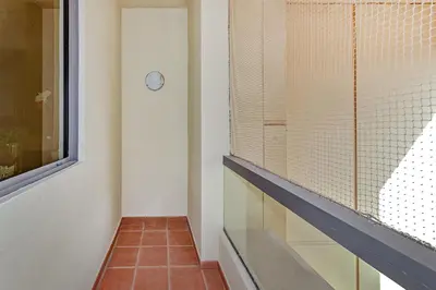 a hallway with a window and a clock on the wall at Marina View Relax - Sadaf 1BR Apartment in Dubai