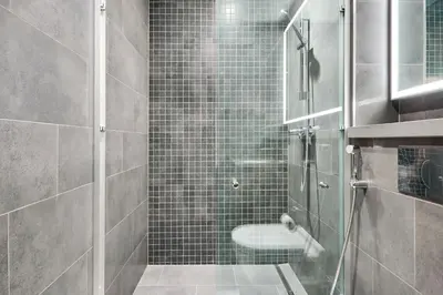 a bathroom with a glass shower with a toilet at STAY BY LATINEM Luxury 1BR Plus Study Holiday Home CB 1808 Near Burj Khalifa in Dubai