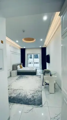 a living room with a couch and a table at Boutique Studio Elegant Stay in Arjan Dubai in Dubai